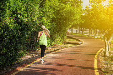 Fototapeta premium Fitness woman training and jogging in summer park. Healthy and sport concept