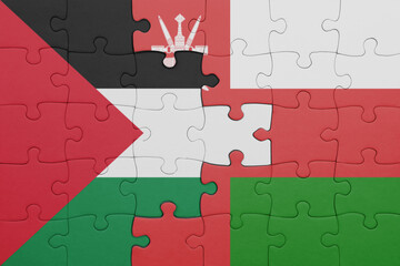puzzle with the colourful national flag of oman and flag of palestine.