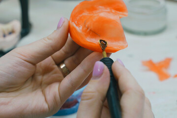 The dental technician makes a wax base and adds wax to form the mold.