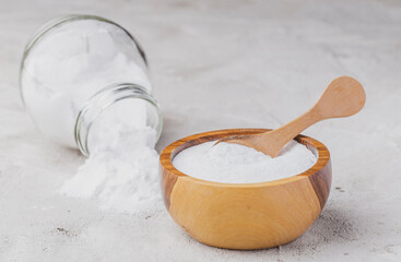 Baking soda in wooden container on rustic surface