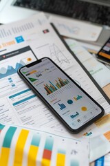 Betting on sports. Phone with graphs and diagrams forecasting football match outcomes on sports newspapers on table. Demonstration of betting calculations. Game, events, analysis, analytics.