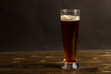dark beer in a glass glass, fresh dark alcoholic beer