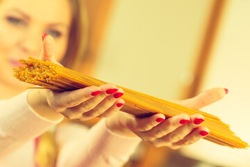 Woman holding long pasta