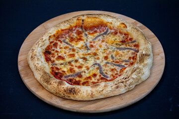Traditional alicci or anchovy pizza, isolated in selective focus