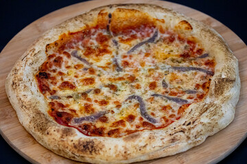 Traditional alicci or anchovy pizza, isolated in selective focus