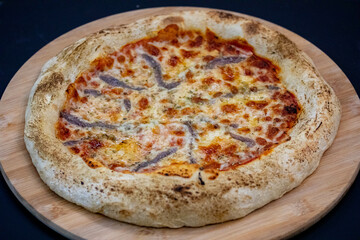 Traditional alicci or anchovy pizza, isolated in selective focus