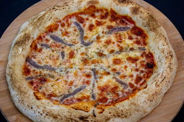 Traditional alicci or anchovy pizza, isolated in selective focus