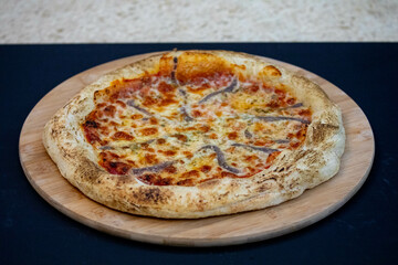 Traditional alicci or anchovy pizza, isolated in selective focus