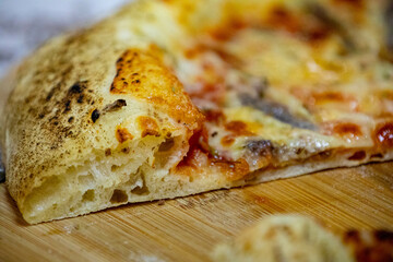Traditional alicci or anchovy pizza, isolated in selective focus
