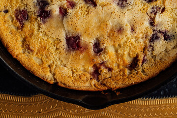close up of cherry clafoutis in cast iron skillet