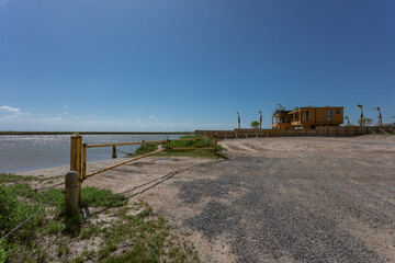 Scenic view of a dock across the water with a distant yellow house