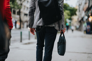Young business professionals walking through the city streets with briefcases and backpacks, heading to a meeting