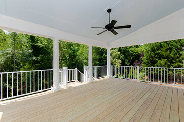 Summer Covered Outdoor Deck with Privacy Trees and Ceiling Fan
