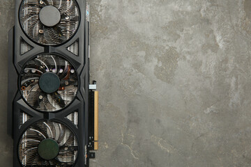 One graphics card on grey table, top view. Space for text