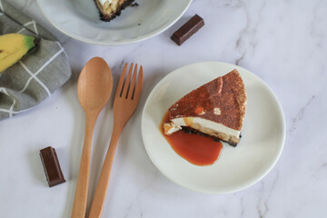 Homemade Banoffee cake made from bananas, whipped cream and a thick caramel sauce on table.