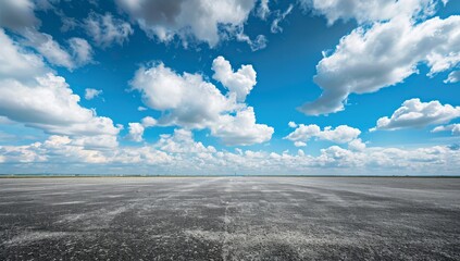 Blue sky and white clouds, empty asphalt floor with space for text or product display, wide angle, panoramic view, clear sky with cloud background