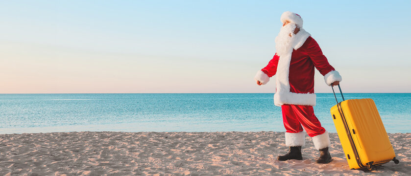 Santa Claus with luggage at sea resort. Christmas vacation - Powered by Adobe