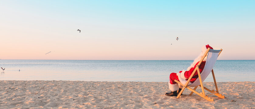 Santa Claus resting at sea resort. Christmas vacation