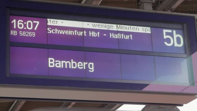 Digital display at a train station showing times and destinations for Bamberg and Schweinfurt