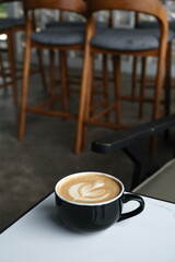 A cup of hot latte coffee on the table for breakfast
