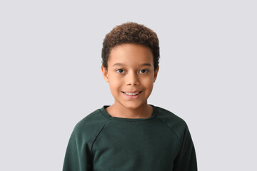 Little African-American boy on white background