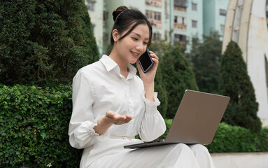 Portrait of young Asian businesswoman in the park
