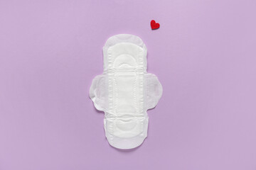 Menstrual pad with red heart on purple background