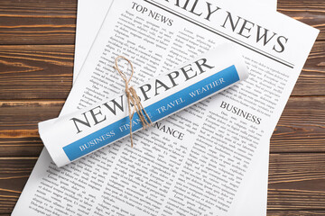 Daily newspapers on wooden background