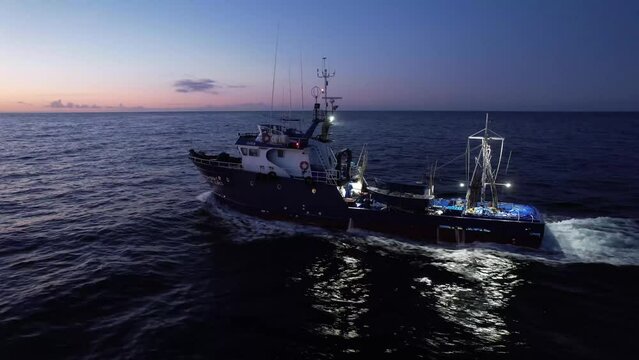 Tuna fishing boat fishing in the Atlantic Ocean in the Azores during sunrise.