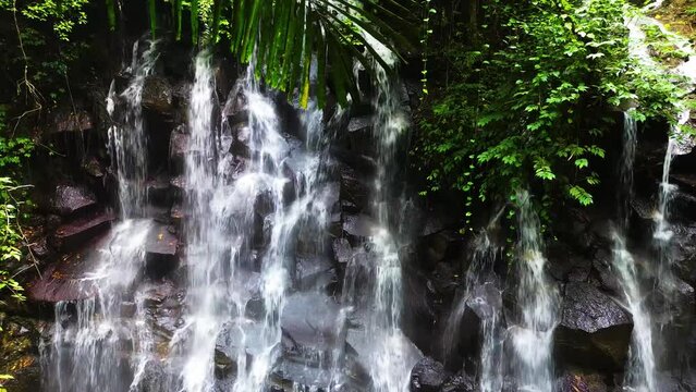 Kanto Lampo, a big cascade waterfall with a shallow pool and a bat cave nearby, Bali, Indonesia