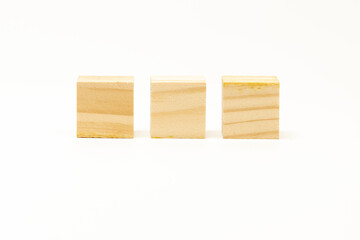 three wooden blocks isolated on white background. showing its wooden grain.