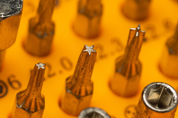close up view of multiple size and type of precision screwdriver bits. Selective focus.