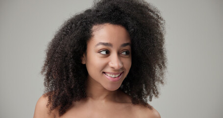 Beauty and healthcare concept - beautiful African American woman with curly afro hairstyle and...