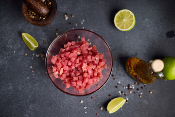 Sliced and chopped tuna fillet in glass bowl at domestic kitchen cooking traditional tartare