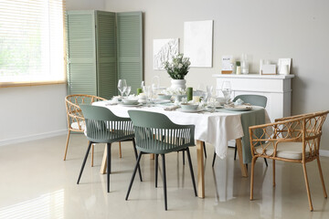 Beautiful table setting with white flowers for wedding celebration in room