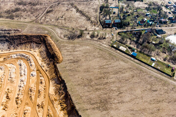 Top view of a sand quarry approaching village houses