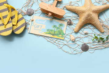 Composition with travel gift voucher, fish net, flip-flops and seashells on color background
