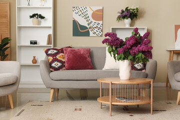 Modern interior of living room with lilac flowers in vase