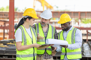 Engineer and foreman worker team checking project at precast concrete factory site, Engineer and builders in hardhats discussing on construction site