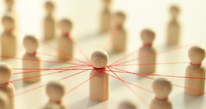 Wooden figures of people tied with red threads