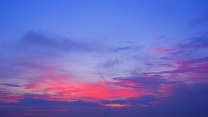 A stunning sunrise with vibrant hues of purple, pink, and blue blending seamlessly across the sky. The clouds are gently dispersed, adding depth and texture to the colorful display. Cloud background.
