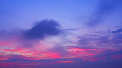 A mesmerizing sunrise with a spectrum of purples, pinks, and blues. Dark clouds add contrast, creating a dynamic and captivating scene with a blend of vibrant colors. Sunrise sky background. 
