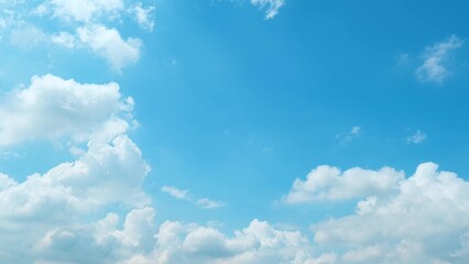A beautiful blue sky filled with large, fluffy white clouds. The clouds are scattered across the...