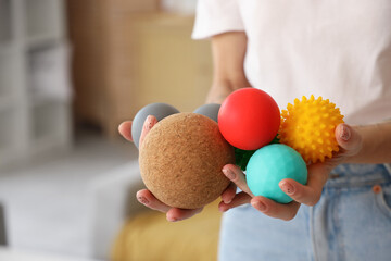 Mature woman with massage balls at home, closeup