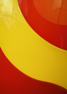 Red and yellow glossy lines and waves. Brightly colored background. Banner, poster, background. Wallpaper. Cooy space