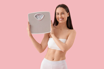 Beautiful young slim happy woman with scales on pink background. Weight loss concept