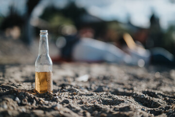 A single beer bottle stands on a sandy beach, encapsulating the essence of relaxation and leisure...