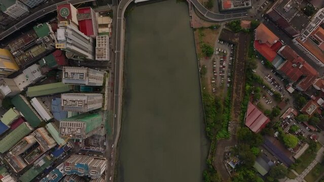 Aerial view of a bridge over the Pasig river in Manila, showcasing the urban landscape and riverbanks of this major travel destination