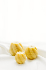 Handmade candles made from natural beeswax on a white background. Hobby. Beekeeping. Small business.