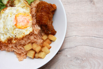Fried rice with tomato sauce Or as we call it American fried rice Served with fried eggs, fried chicken, fresh stir-fry, and fried bread.